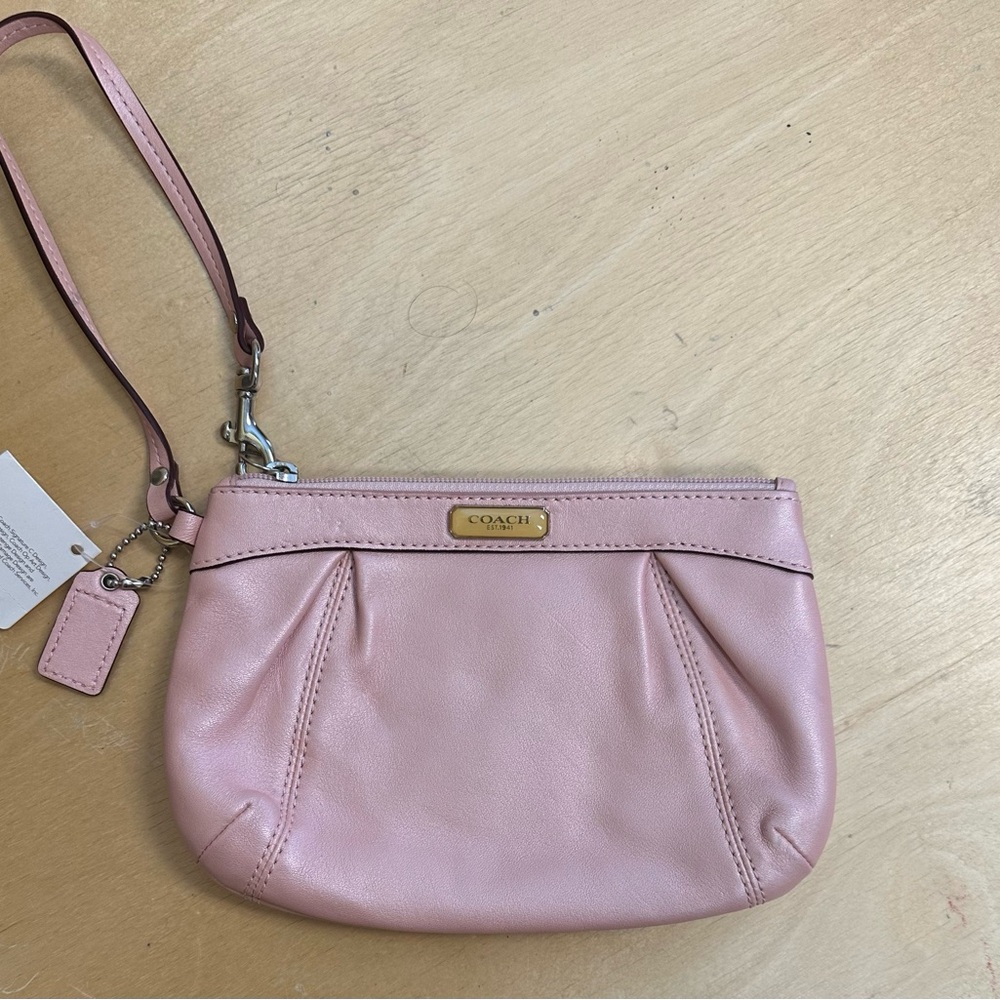 Coach Pink Leather Wristlet
One inside pocket 
Some marks on back